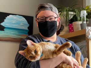 Parker holding a foster cat